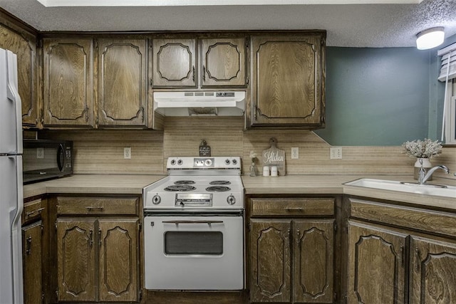 kitchen featuring white appliances, sink, decorative backsplash, a textured ceiling, and dark brown cabinets