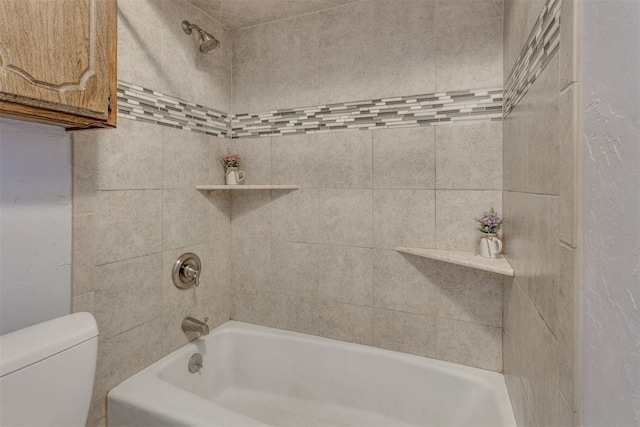 bathroom with tiled shower / bath combo and toilet