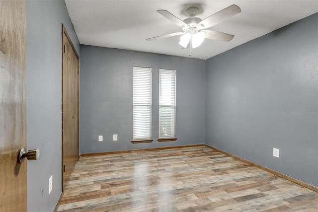 empty room featuring ceiling fan and light hardwood / wood-style flooring