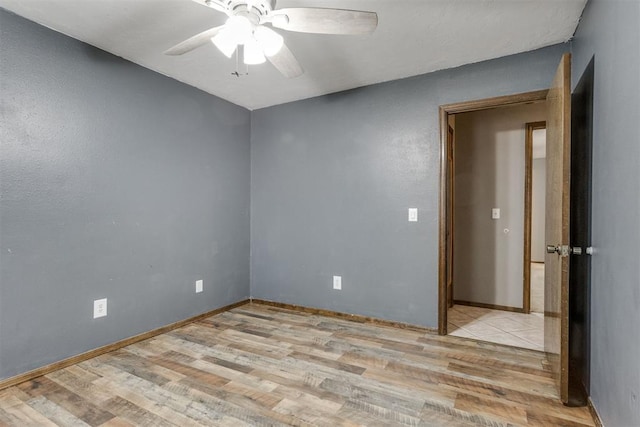 spare room with ceiling fan and light hardwood / wood-style floors