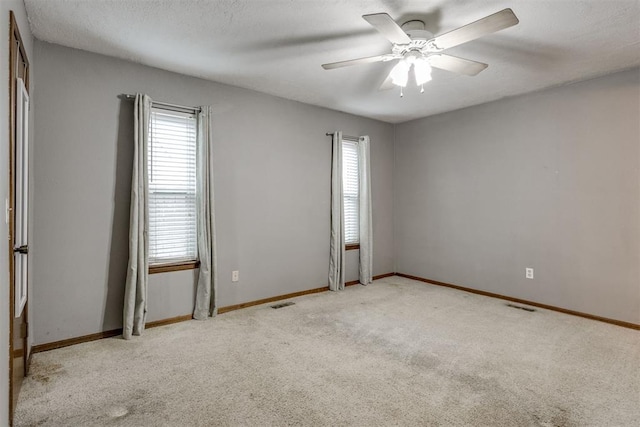 spare room featuring ceiling fan and light colored carpet