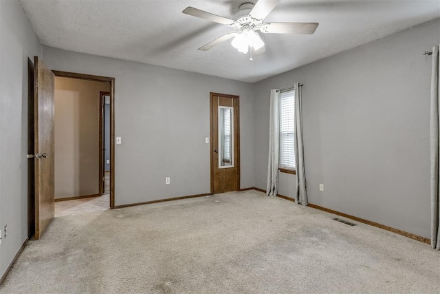 carpeted empty room with a textured ceiling and ceiling fan