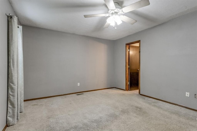 carpeted empty room featuring ceiling fan