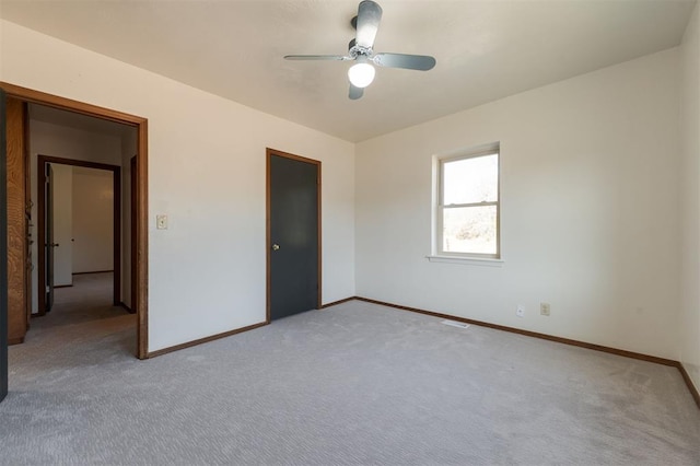 unfurnished bedroom featuring light colored carpet and ceiling fan