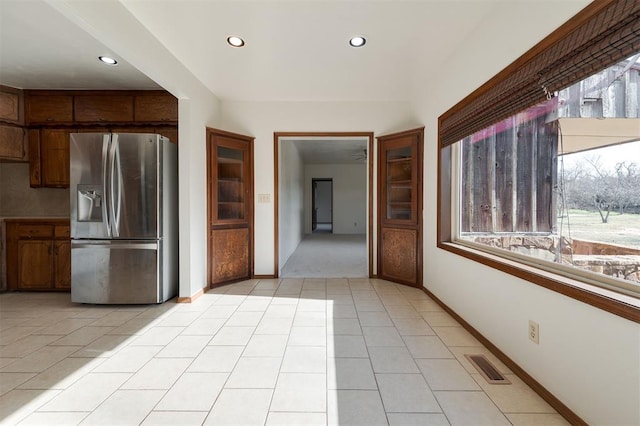 kitchen featuring stainless steel fridge and light tile patterned flooring