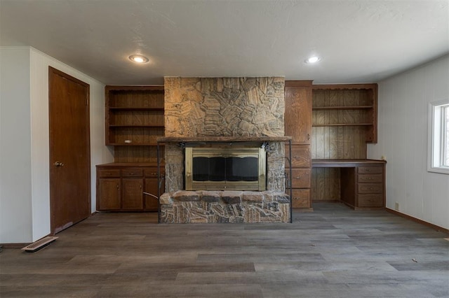 unfurnished living room featuring a fireplace and hardwood / wood-style flooring