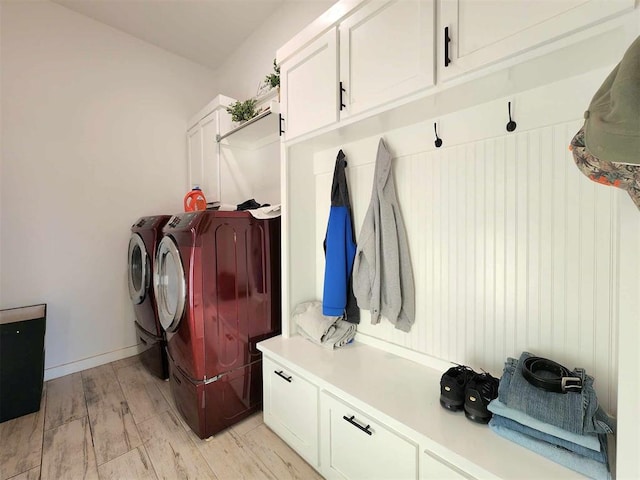 mudroom with washer and clothes dryer and light hardwood / wood-style floors