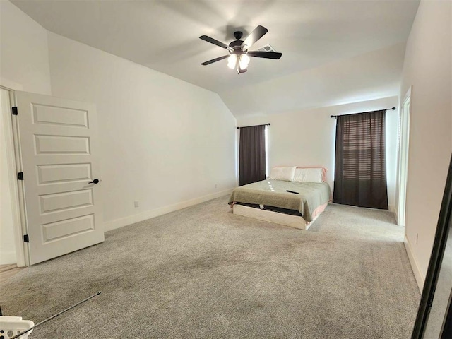 unfurnished bedroom featuring ceiling fan, carpet floors, and vaulted ceiling