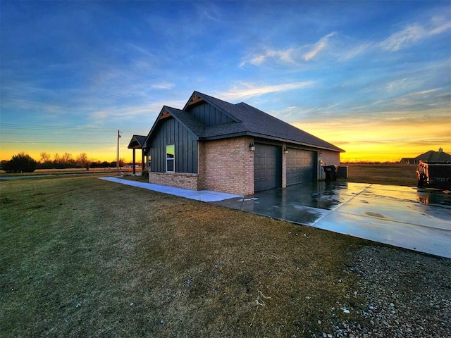 property exterior at dusk featuring a yard