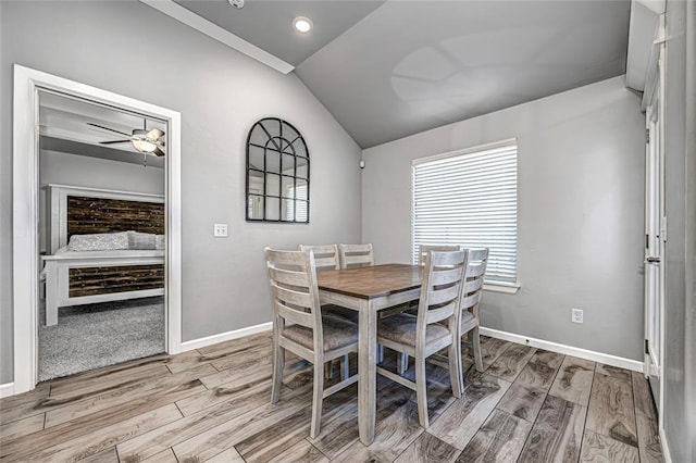 dining space with ceiling fan, light hardwood / wood-style floors, and lofted ceiling