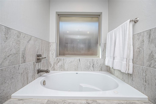 bathroom with a tub to relax in