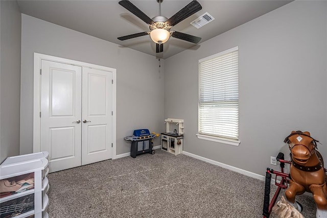 miscellaneous room featuring light carpet and ceiling fan