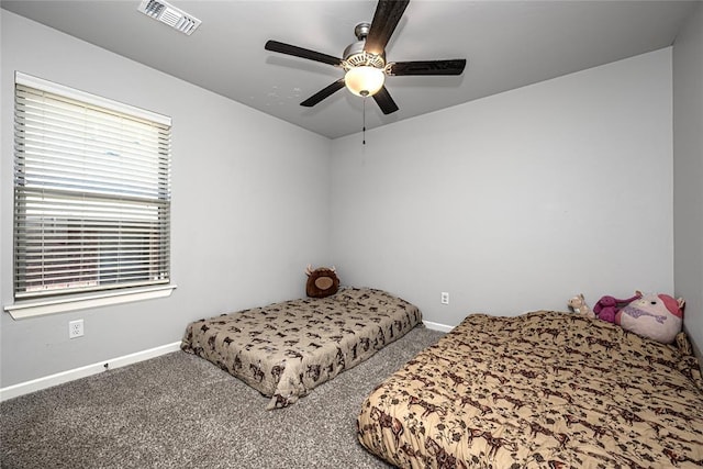 bedroom with ceiling fan and carpet floors