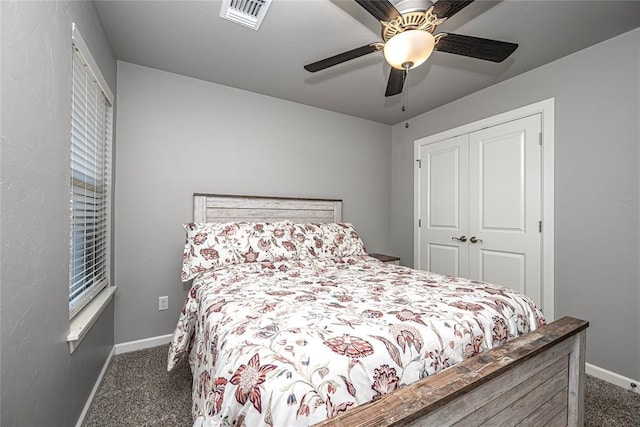 bedroom with dark colored carpet, a closet, and ceiling fan