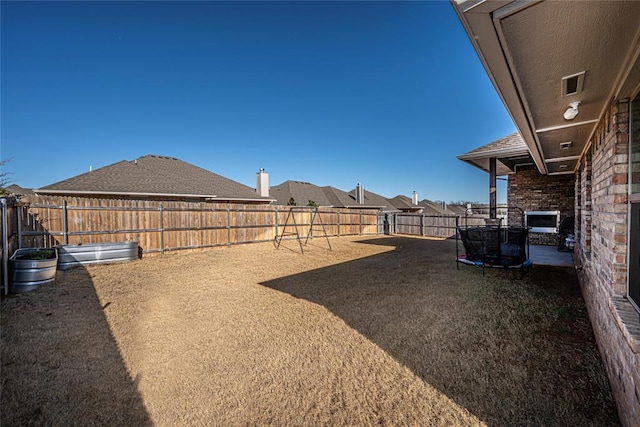 view of yard with a trampoline