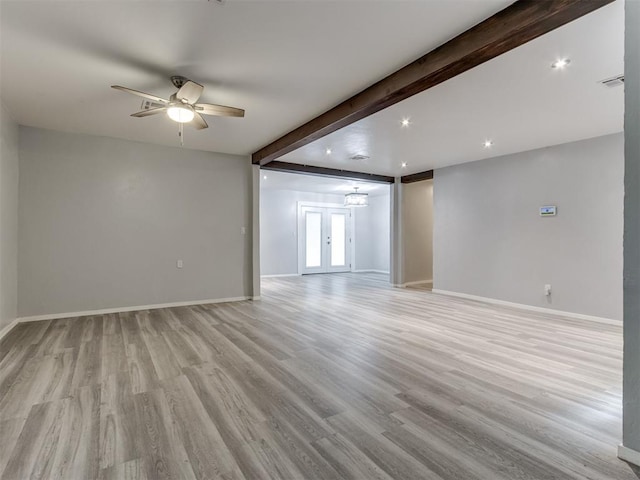 empty room with ceiling fan, beam ceiling, light wood-type flooring, and french doors