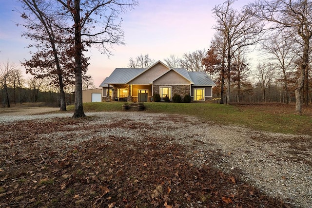 view of front facade with a porch and an outbuilding