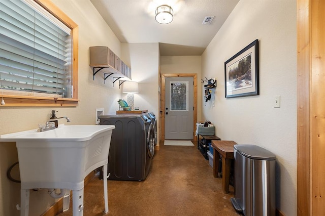 laundry area with sink and independent washer and dryer