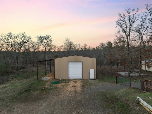 garage at dusk with a carport