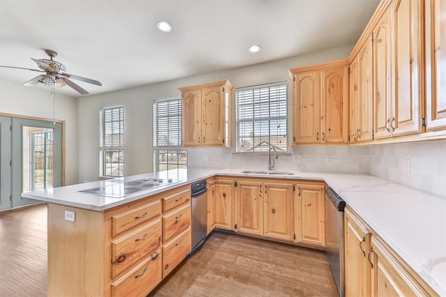 kitchen featuring stainless steel dishwasher, electric stovetop, a sink, and light brown cabinetry