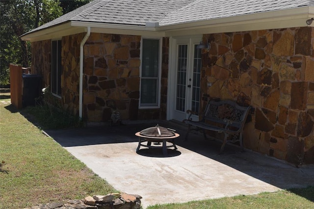 view of patio / terrace featuring a fire pit and french doors