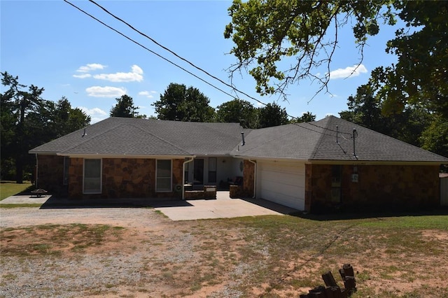 single story home featuring a front lawn and a garage