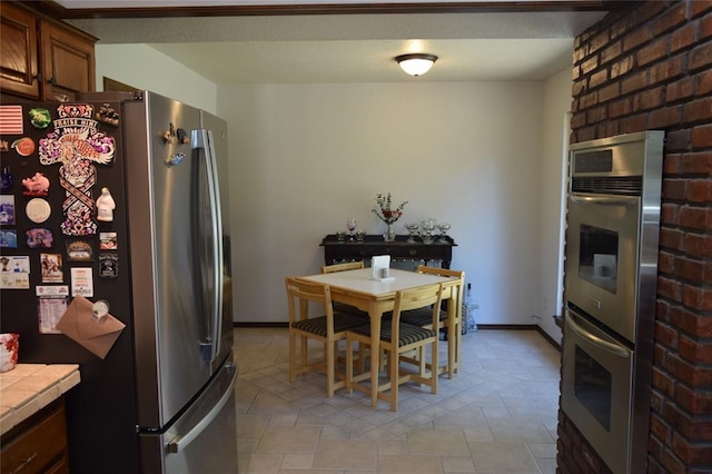 kitchen featuring tile countertops and stainless steel appliances