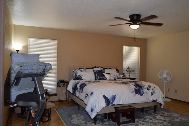 bedroom with multiple windows and ceiling fan