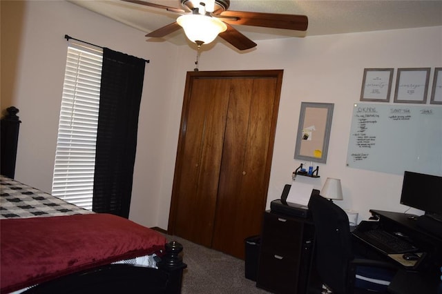 carpeted bedroom featuring ceiling fan and a closet