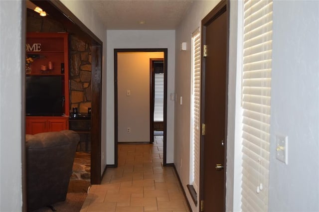 hallway featuring light tile patterned floors