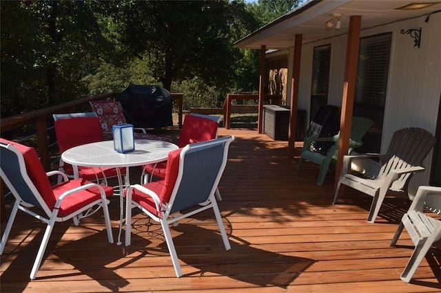 wooden deck featuring a grill