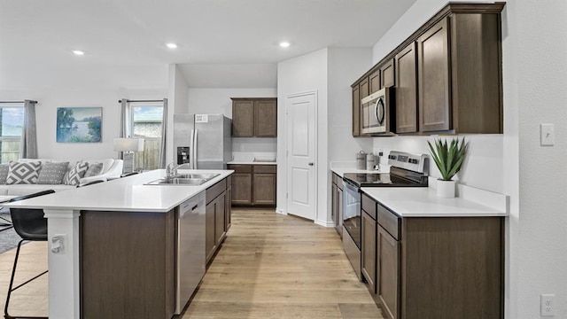 kitchen featuring dark brown cabinetry, sink, a healthy amount of sunlight, and appliances with stainless steel finishes