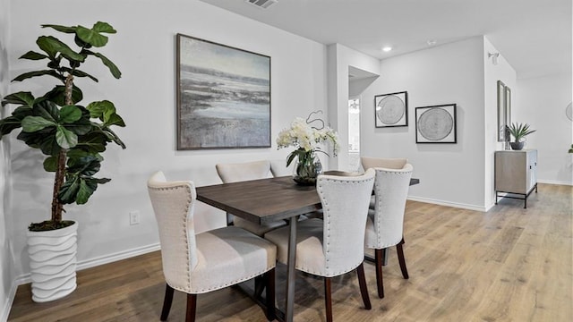 dining space with light hardwood / wood-style floors