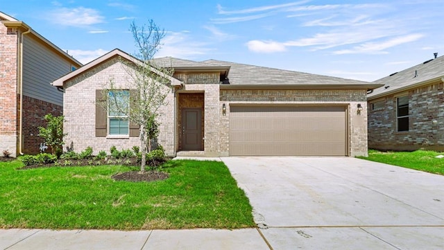 view of front of home with a garage and a front lawn