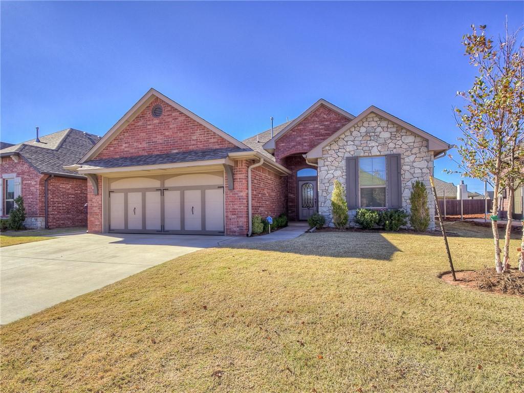 ranch-style home with a front yard and a garage