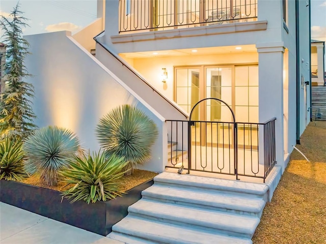 view of exterior entry featuring a balcony