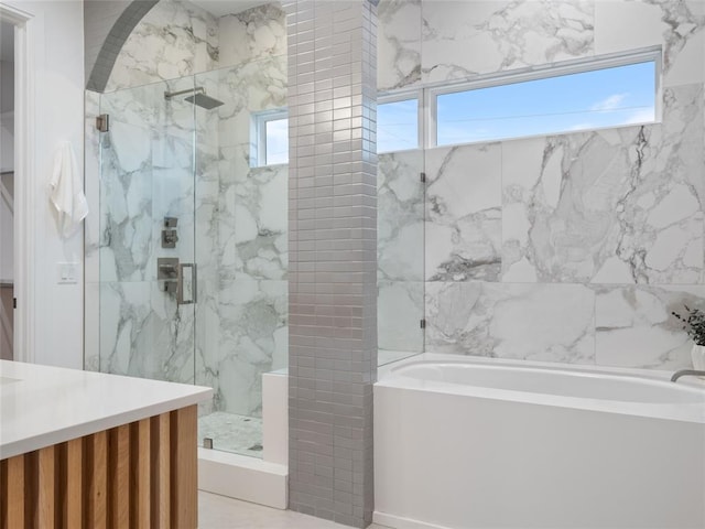 bathroom featuring vanity and shower with separate bathtub