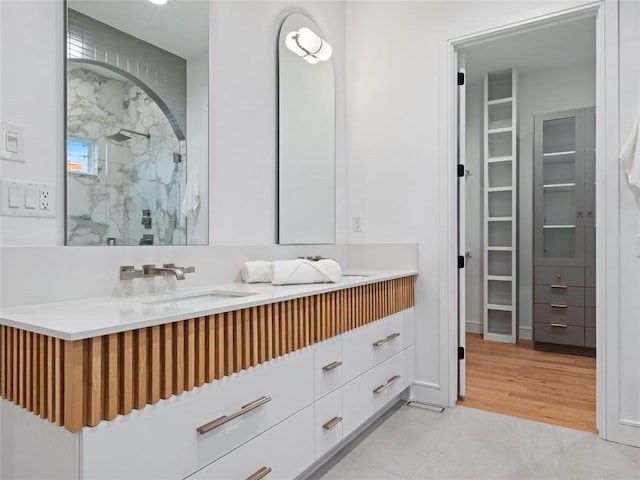 bathroom with vanity, tile patterned floors, and walk in shower