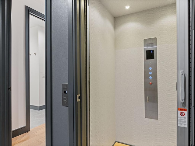 interior space with wood-type flooring and elevator