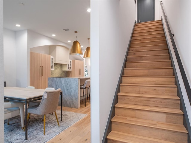 stairs featuring wood-type flooring