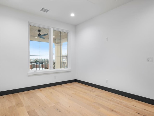 empty room featuring light hardwood / wood-style flooring and ceiling fan