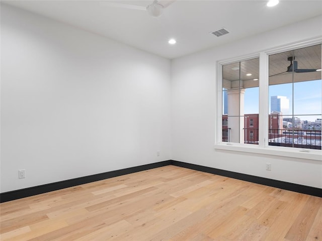 spare room with hardwood / wood-style floors and ceiling fan