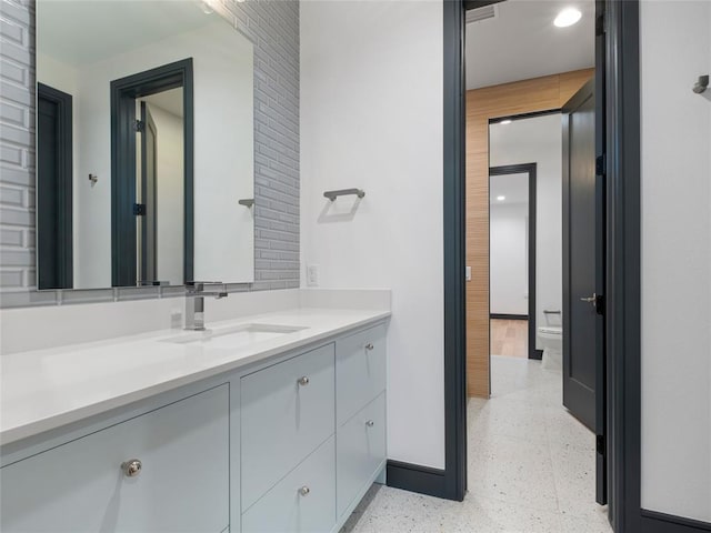 bathroom featuring vanity and toilet