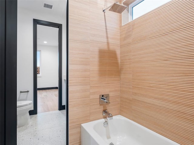 bathroom featuring shower / bathing tub combination and toilet