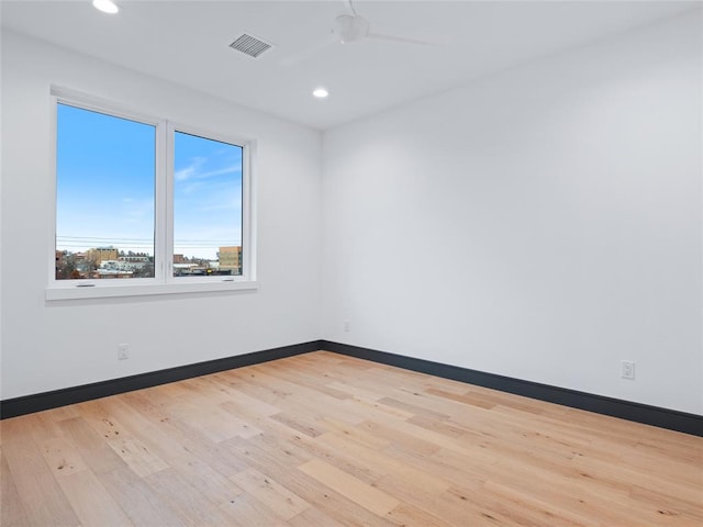 spare room featuring ceiling fan and light hardwood / wood-style floors