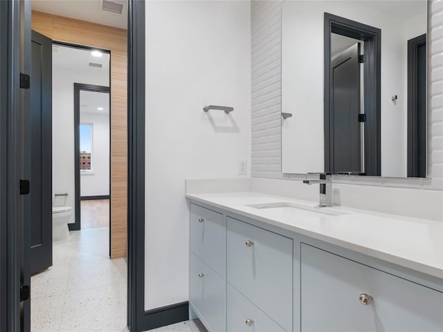 bathroom featuring vanity and toilet