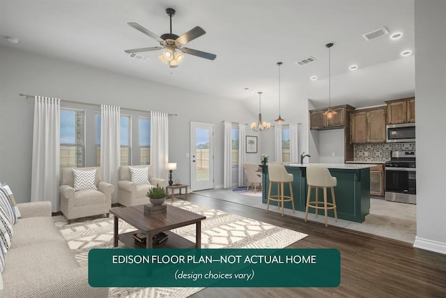 unfurnished living room featuring ceiling fan with notable chandelier, vaulted ceiling, and dark wood-type flooring