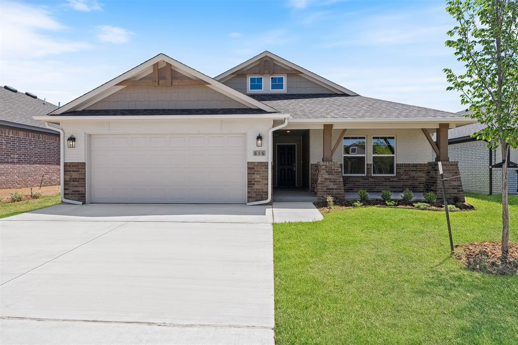 616 Argos Rd, Yukon, OK 73099 - craftsman house with driveway, a garage, a front lawn, brick siding, and a shingled roof