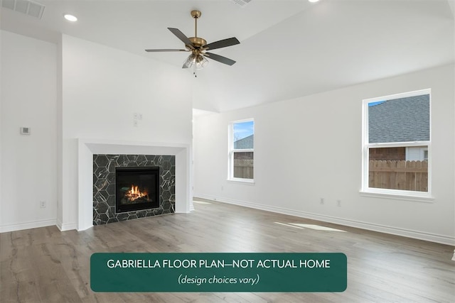 unfurnished living room featuring ceiling fan, hardwood / wood-style floors, and vaulted ceiling