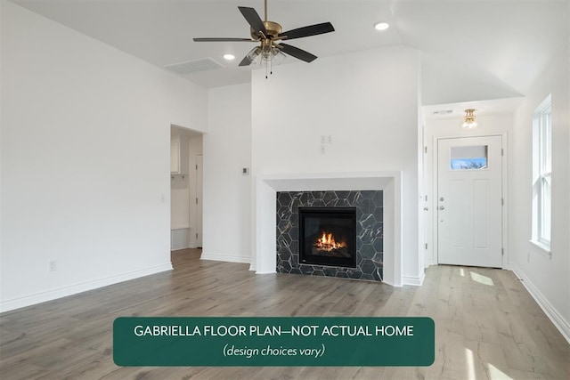 unfurnished living room featuring hardwood / wood-style flooring, ceiling fan, and high vaulted ceiling